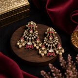 Luxury traditional gold earrings with pink stones and pearl drops.